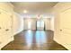 Open living room featuring wood flooring, ceiling fan, and natural light at 353 Vista Ln, Woodstock, GA 30189