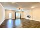 Bright living room featuring hardwood floors, fireplace, and a ceiling fan at 353 Vista Ln, Woodstock, GA 30189