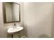 Cozy powder room with a pedestal sink and a framed mirror at 353 Vista Ln, Woodstock, GA 30189