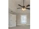 Large bedroom featuring tray ceilings, carpet, and a ceiling fan at 2541 Berwick Walk, Snellville, GA 30078