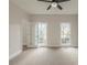 Carpeted bedroom with ceiling fan and glass paneled doors to another room at 2541 Berwick Walk, Snellville, GA 30078