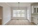 Bright dining room featuring hardwood floors, modern lighting, and views of the backyard at 2541 Berwick Walk, Snellville, GA 30078