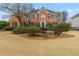 Charming two-story brick home featuring manicured landscaping and a classic architectural design at 2541 Berwick Walk, Snellville, GA 30078