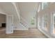 Bright living room featuring high ceilings, many windows, hardwood floors, and a staircase at 2541 Berwick Walk, Snellville, GA 30078