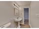 Classic pedestal sink with a decorative mirror and a door leading to another room at 250 Southmoor Cir, Stockbridge, GA 30281