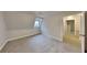 A cozy carpeted bedroom featuring a natural light window and neutral walls at 250 Southmoor Cir, Stockbridge, GA 30281