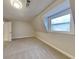 Cozy carpeted bedroom featuring a natural light window and neutral walls at 250 Southmoor Cir, Stockbridge, GA 30281