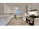 Classic kitchen design with bright, white cabinets, stainless steel appliances, and ample counter space at 250 Southmoor Cir, Stockbridge, GA 30281