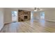 Bright and airy living room with a stone fireplace, updated flooring, and ample natural light at 250 Southmoor Cir, Stockbridge, GA 30281