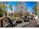 Back deck features a fire pit, a gas grill, and a view of the fenced yard at 660 Old Ivy Ne Rd, Atlanta, GA 30342