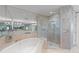 Bathroom featuring a soaking tub, walk-in shower, large mirror and double vanity at 750 Park Ne Ave # 21E, Atlanta, GA 30326