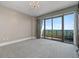 Spacious bedroom featuring a chandelier, large windows, and access to a private balcony at 750 Park Ne Ave # 21E, Atlanta, GA 30326