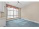 Bedroom with large window, neutral walls and blue carpet at 750 Park Ne Ave # 21E, Atlanta, GA 30326