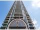 Tall building showcasing a modern facade with balconies, arched entrance, and stylish design against a blue sky at 750 Park Ne Ave # 21E, Atlanta, GA 30326