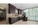 Modern coffee bar area featuring dark wood cabinetry, stainless steel appliances, and beverage service station at 750 Park Ne Ave # 21E, Atlanta, GA 30326