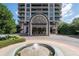 Grand building entrance with a fountain, lush landscaping, and prominent architectural details creating an inviting facade at 750 Park Ne Ave # 21E, Atlanta, GA 30326