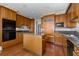 Traditional style kitchen with wood cabinets, center island, and granite countertops at 750 Park Ne Ave # 21E, Atlanta, GA 30326