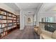 Library showcasing expansive bookshelves with natural light and inviting armchairs at 750 Park Ne Ave # 21E, Atlanta, GA 30326
