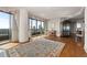 Living room with hardwood floors, piano, and a large oriental rug at 750 Park Ne Ave # 21E, Atlanta, GA 30326