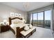 Bright main bedroom with a balcony, chandelier, wood furniture and patterned carpet at 750 Park Ne Ave # 21E, Atlanta, GA 30326