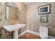 Elegant powder room featuring a pedestal sink, decorative wallpaper, and ornate gold mirror at 750 Park Ne Ave # 21E, Atlanta, GA 30326