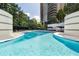 Large swimming pool with lounge chairs, umbrellas, and surrounded by greenery, offering a luxurious outdoor experience at 750 Park Ne Ave # 21E, Atlanta, GA 30326