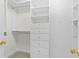 Walk-in closet with white cabinets and drawers, providing ample storage space at 750 Park Ne Ave # 21E, Atlanta, GA 30326