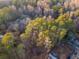 Aerial view of a wooded property featuring green and bare trees at 2057 Sugar Pike Rd, Woodstock, GA 30188