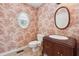 Bathroom with a floral theme wallpaper, a toilet and a sink with wood cabinet at 2057 Sugar Pike Rd, Woodstock, GA 30188