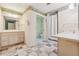 Bathroom featuring marble floors, dual vanities, and shower with glass enclosure and shower curtain at 2057 Sugar Pike Rd, Woodstock, GA 30188