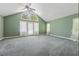 Spacious bedroom with vaulted ceilings, large arched window, and sheer white curtains at 2057 Sugar Pike Rd, Woodstock, GA 30188