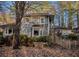 Exterior view of home with wood siding and lush surrounding trees at 2057 Sugar Pike Rd, Woodstock, GA 30188