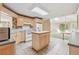 Open kitchen with a center island, light wood cabinets, and views of living room at 2057 Sugar Pike Rd, Woodstock, GA 30188