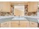 Close-up of kitchen sink area with cabinets and window view to living space at 2057 Sugar Pike Rd, Woodstock, GA 30188