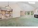 Spacious living room with a fireplace and views into kitchen at 2057 Sugar Pike Rd, Woodstock, GA 30188