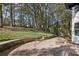 View of a large backyard with stone patio and mature trees at 2190 Lakeway Dr, Dacula, GA 30019