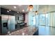 Modern kitchen features stainless steel appliances, granite counters and industrial pendant lighting at 400 W Peachtree Nw St # 2808, Atlanta, GA 30308