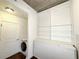 Functional laundry area with washer, dryer, and storage shelving at 400 W Peachtree Nw St # 2808, Atlanta, GA 30308
