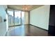 Modern living room featuring hardwood floors, floor-to-ceiling windows with cityscape view, and natural light at 400 W Peachtree Nw St # 2808, Atlanta, GA 30308