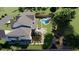 Aerial view of a home's backyard featuring a pool, expansive lawn, and lush landscaping at 401 Lynne Cir, Alpharetta, GA 30009