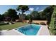 Beautiful backyard featuring a sparkling pool, well-manicured lawn, and mature trees at 401 Lynne Cir, Alpharetta, GA 30009