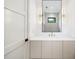 Stylish bathroom features a large mirror, modern vanity, and sconces, creating a luxurious feel at 401 Lynne Cir, Alpharetta, GA 30009