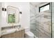 Bathroom featuring a stone vanity top, modern fixtures, and a glass shower with patterned tile at 401 Lynne Cir, Alpharetta, GA 30009