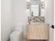 Stylish powder room featuring a modern vanity with marble countertop and gold fixtures at 401 Lynne Cir, Alpharetta, GA 30009