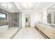 Bright bathroom boasts a soaking tub, glass shower, and marble-topped double vanity at 401 Lynne Cir, Alpharetta, GA 30009