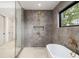 Modern bathroom features a free-standing soaking tub, large glass shower, and stylish fixtures at 401 Lynne Cir, Alpharetta, GA 30009
