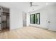 Bright bedroom featuring white walls, wood floors, black trimmed windows and an adjacent walk-in closet at 401 Lynne Circle, Alpharetta, GA 30009