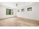 Sunlit bedroom with modern ceiling fan, hardwood floors, and several large windows at 401 Lynne Cir, Alpharetta, GA 30009