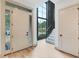 Bright foyer with a large window overlooking the front yard and stairs to the second floor at 401 Lynne Cir, Alpharetta, GA 30009