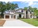 View of driveway leading to the attached garage and the front facade of the home at 401 Lynne Cir, Alpharetta, GA 30009